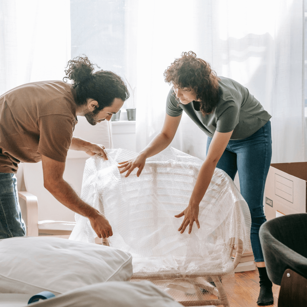 A picture of two people packing their furniture.