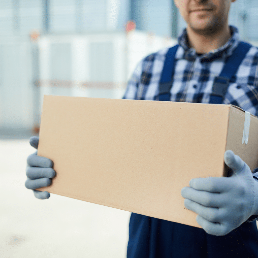 A picture of a man holding a box with gloves.
