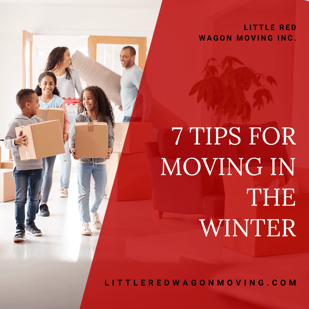 A picture of a family carrying moving boxes into their home